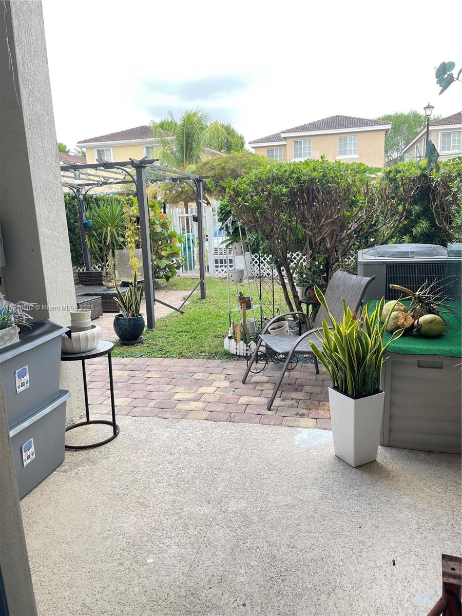 27563 Southwest 139th Place, Unit B Homestead, FL 33032 - Photo 16 of 17 a view of a porch with furniture