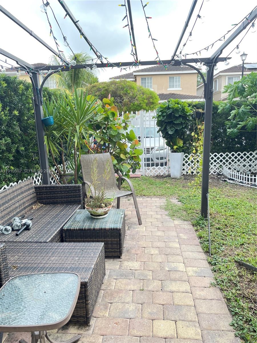 27563 Southwest 139th Place, Unit B Homestead, FL 33032 - Photo 17 of 17 a view of a couches in patio and a yard