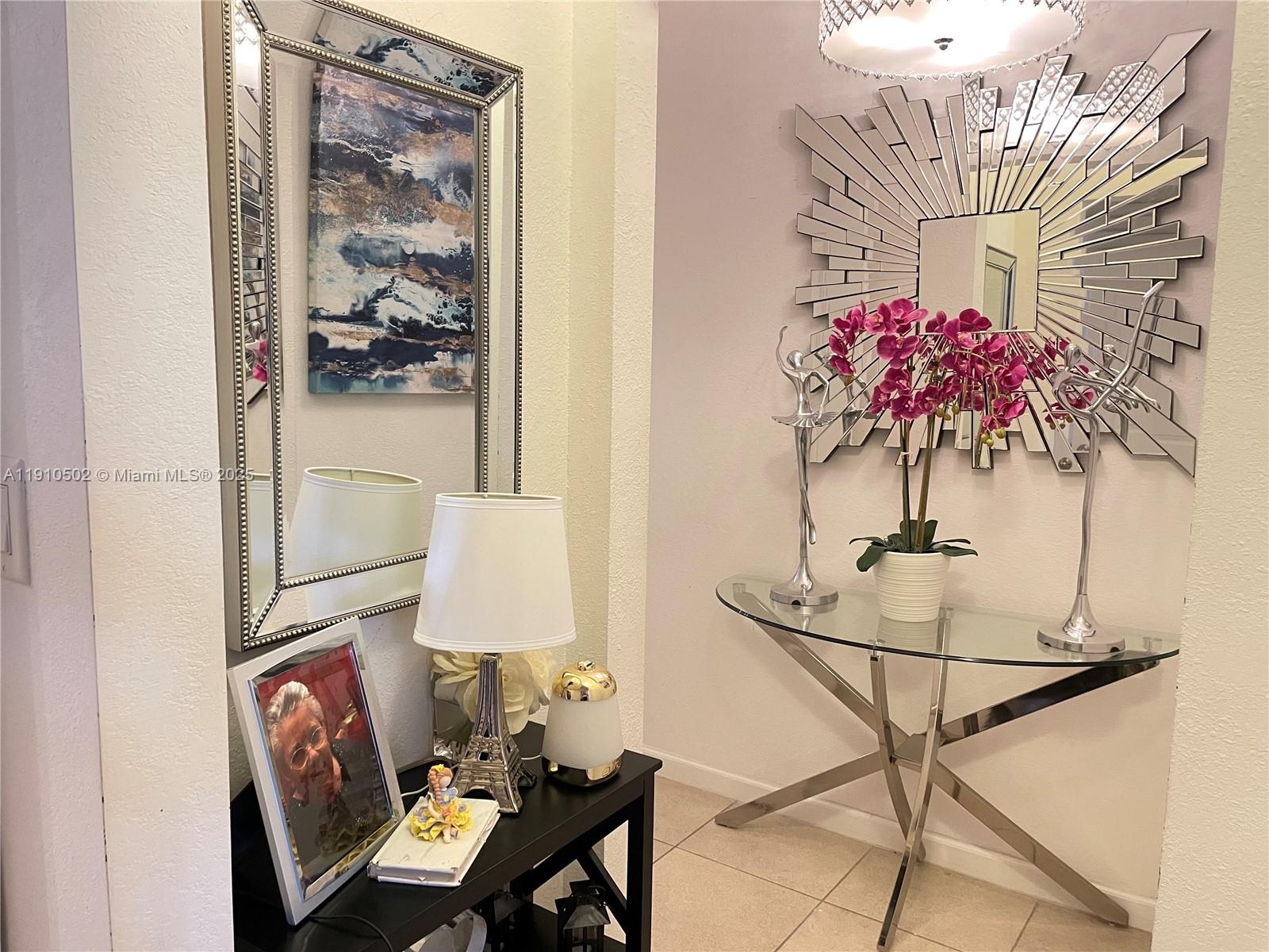 27563 Southwest 139th Place, Unit B Homestead, FL 33032 - Photo 2 of 17 a view of a dining room with furniture and a chandelier