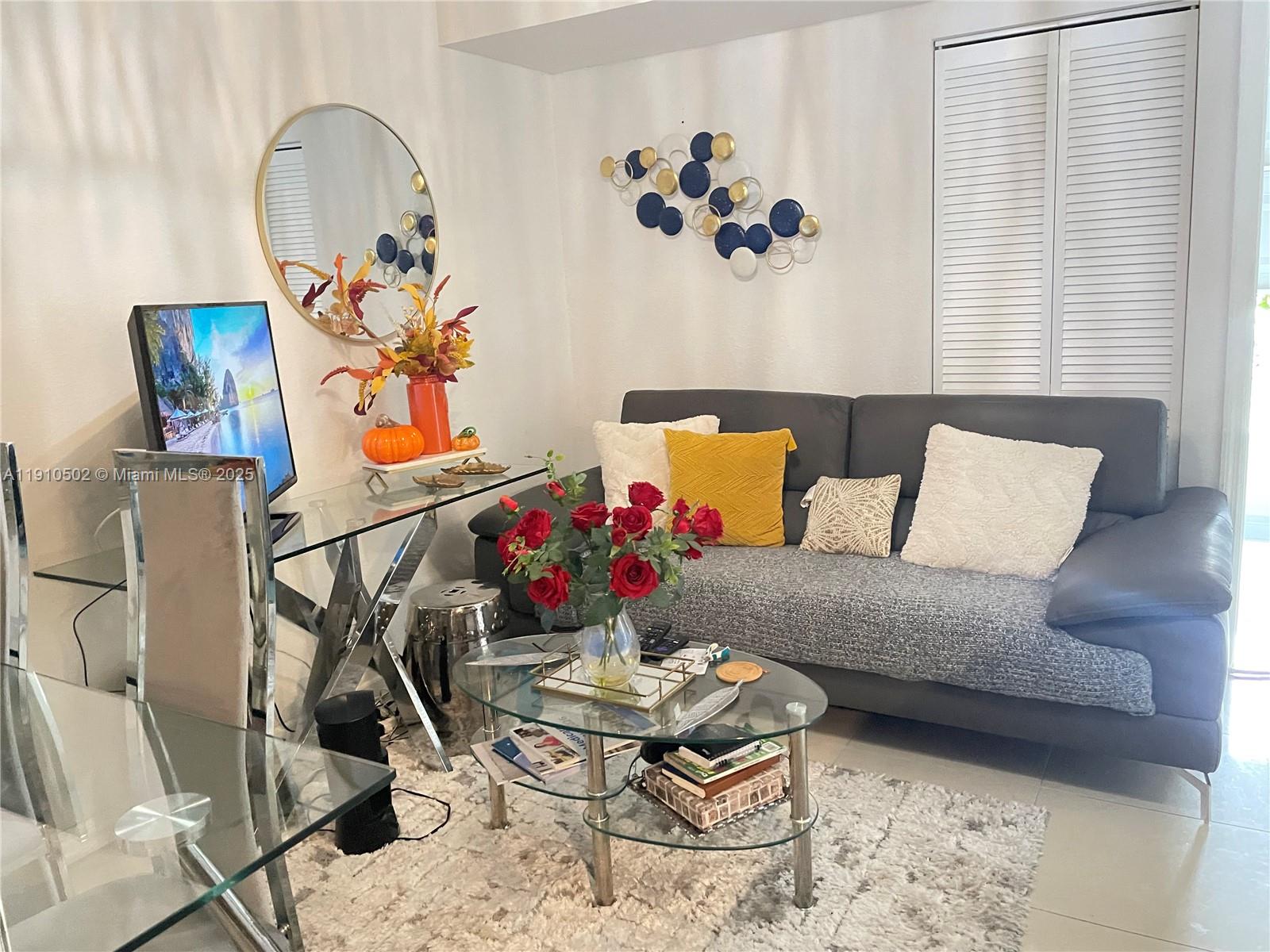 27563 Southwest 139th Place, Unit B Homestead, FL 33032 - Photo 6 of 17 a living room with a couch and painting on the wall