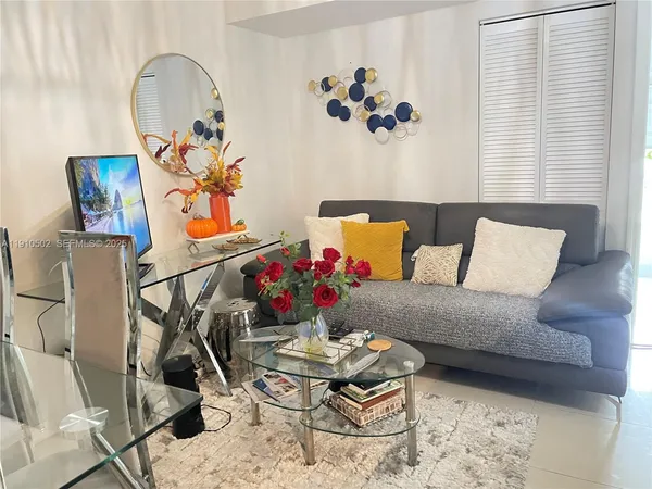 a living room with a couch and painting on the wall