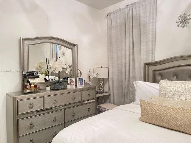 a living room with furniture and a mirror
