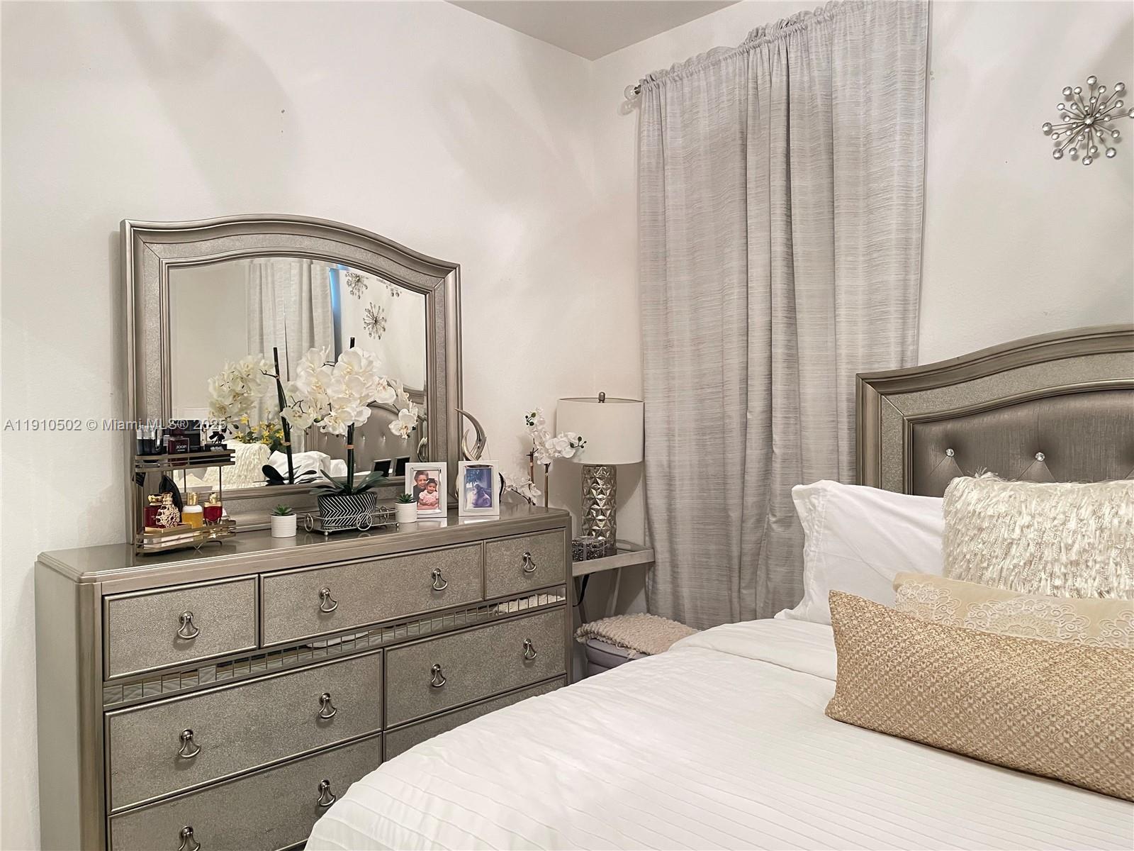 27563 Southwest 139th Place, Unit B Homestead, FL 33032 - Photo 9 of 17 a living room with furniture and a mirror