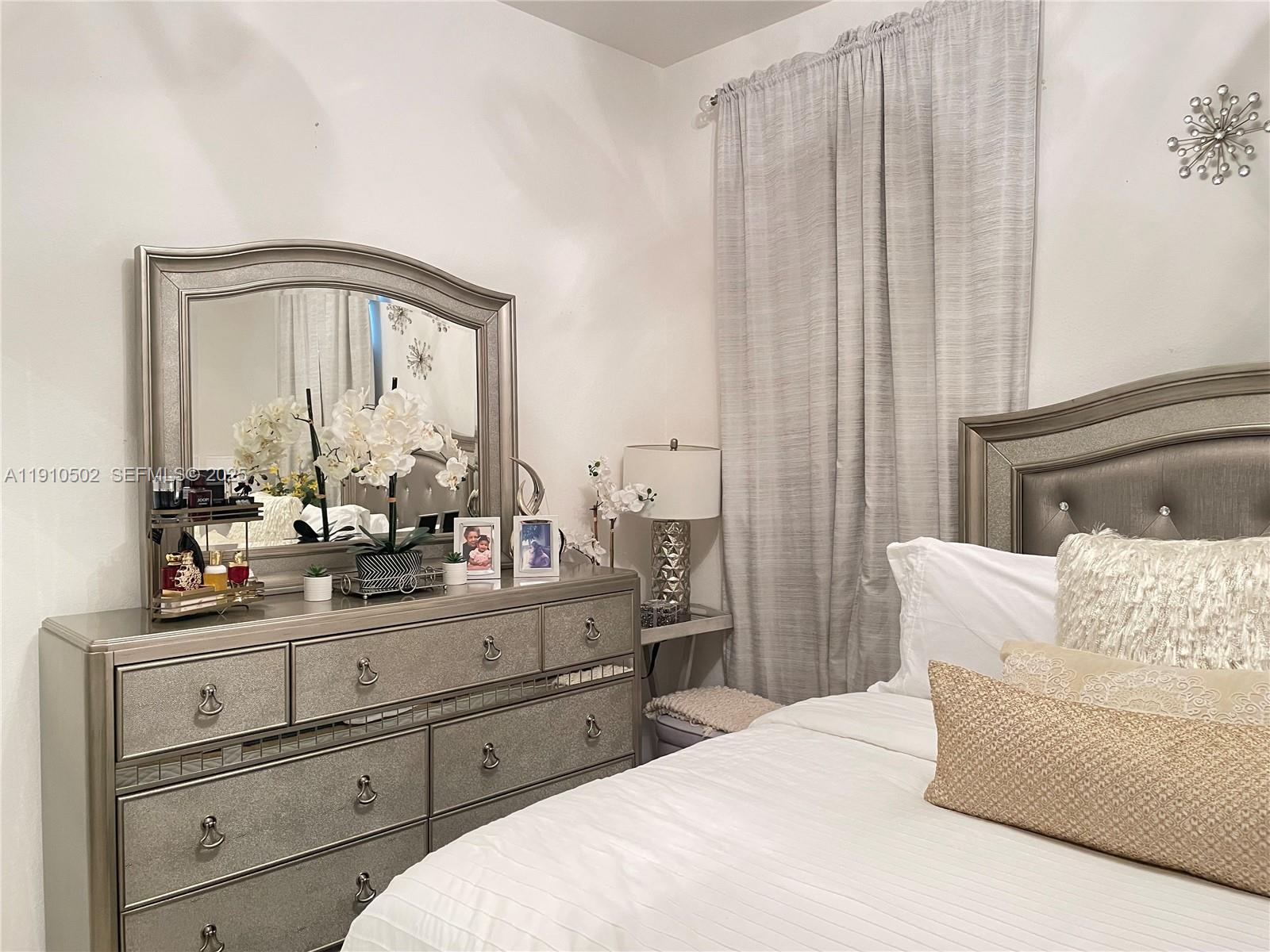 27563 Southwest 139th Place, Unit B Homestead, FL 33032 - Photo 9 of 17 a living room with furniture and a mirror