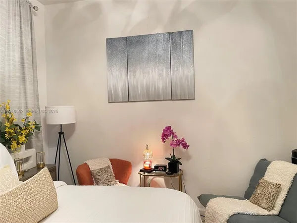 a living room with furniture and flowers