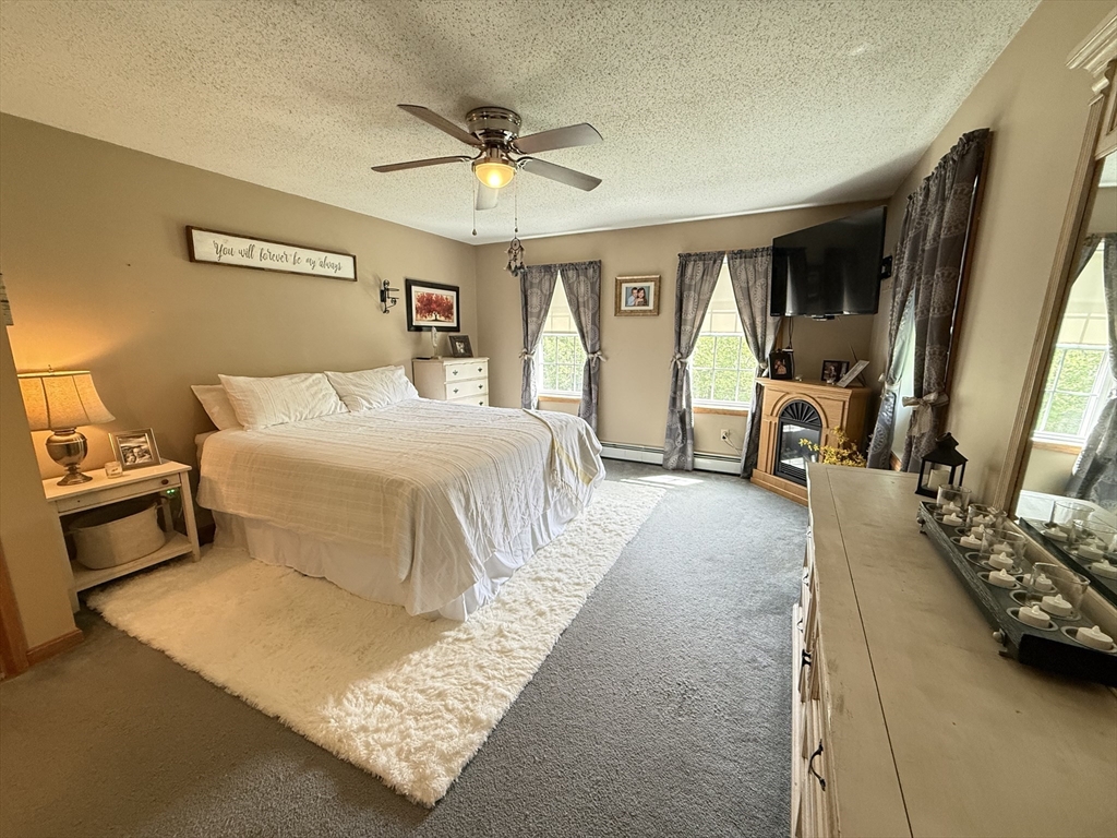 222 Bridge Street Warren, MA 01083 - Photo 18 of 40 a bedroom with a large bed and a chandelier