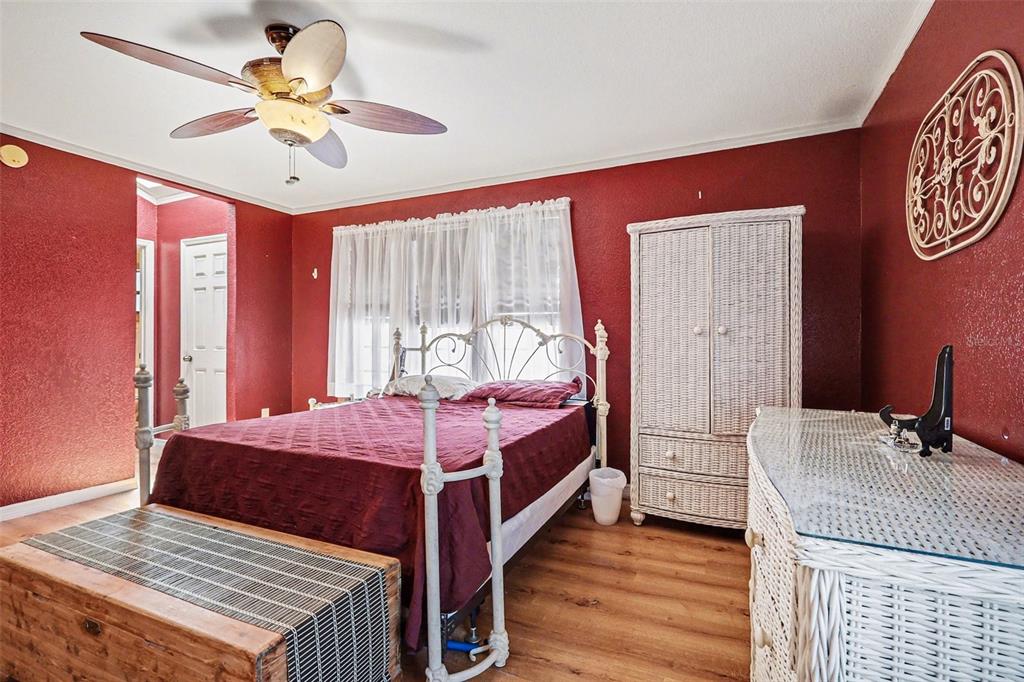 58 Deer Road Frostproof, FL 33843 - Photo 13 of 20 a bedroom with a bed and a chandelier