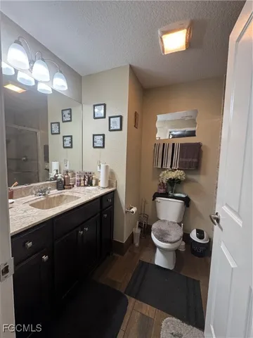 a bathroom with a double vanity sink toilet and mirror