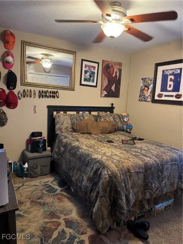 a bathroom with a granite countertop sink and a toilet