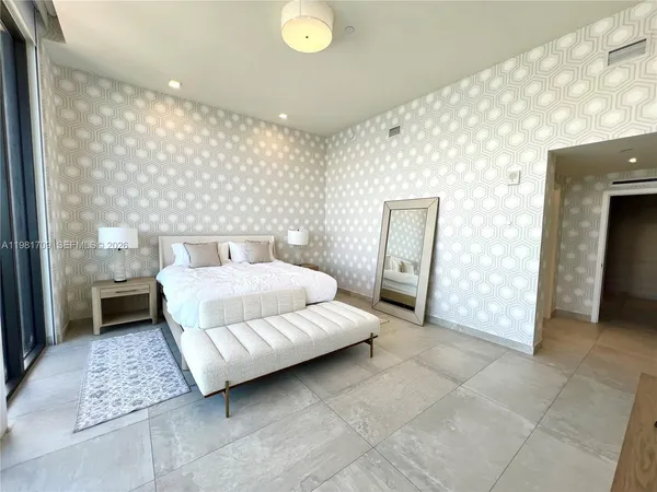 a bedroom with a bed and a night stand
