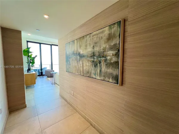a large kitchen with stainless steel appliances kitchen island granite countertop a large counter top and a fireplace