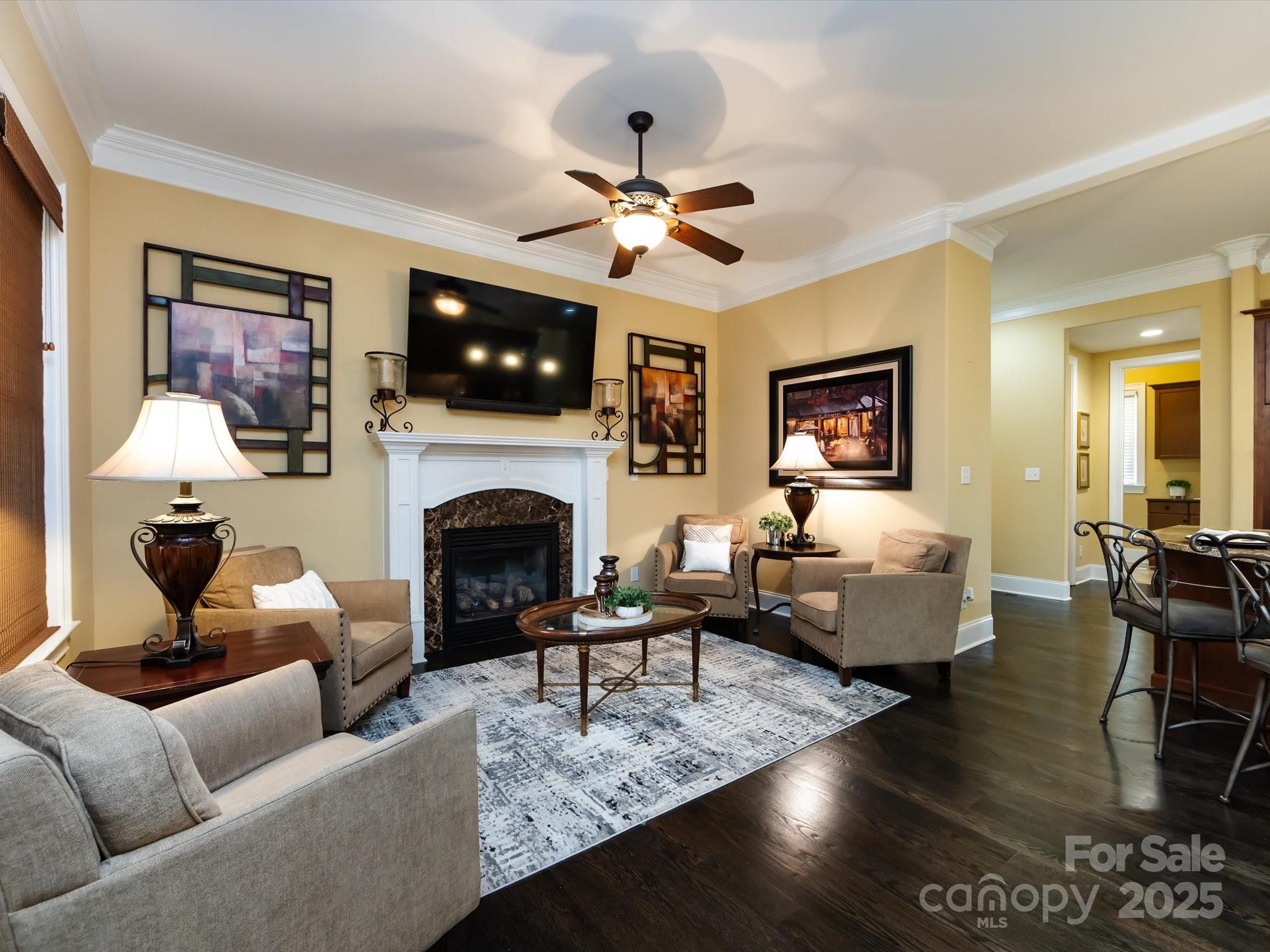 132 Chaska Loop Troutman, NC 28166 - Photo 12 of 48 a living room with furniture a flat screen tv and a fireplace