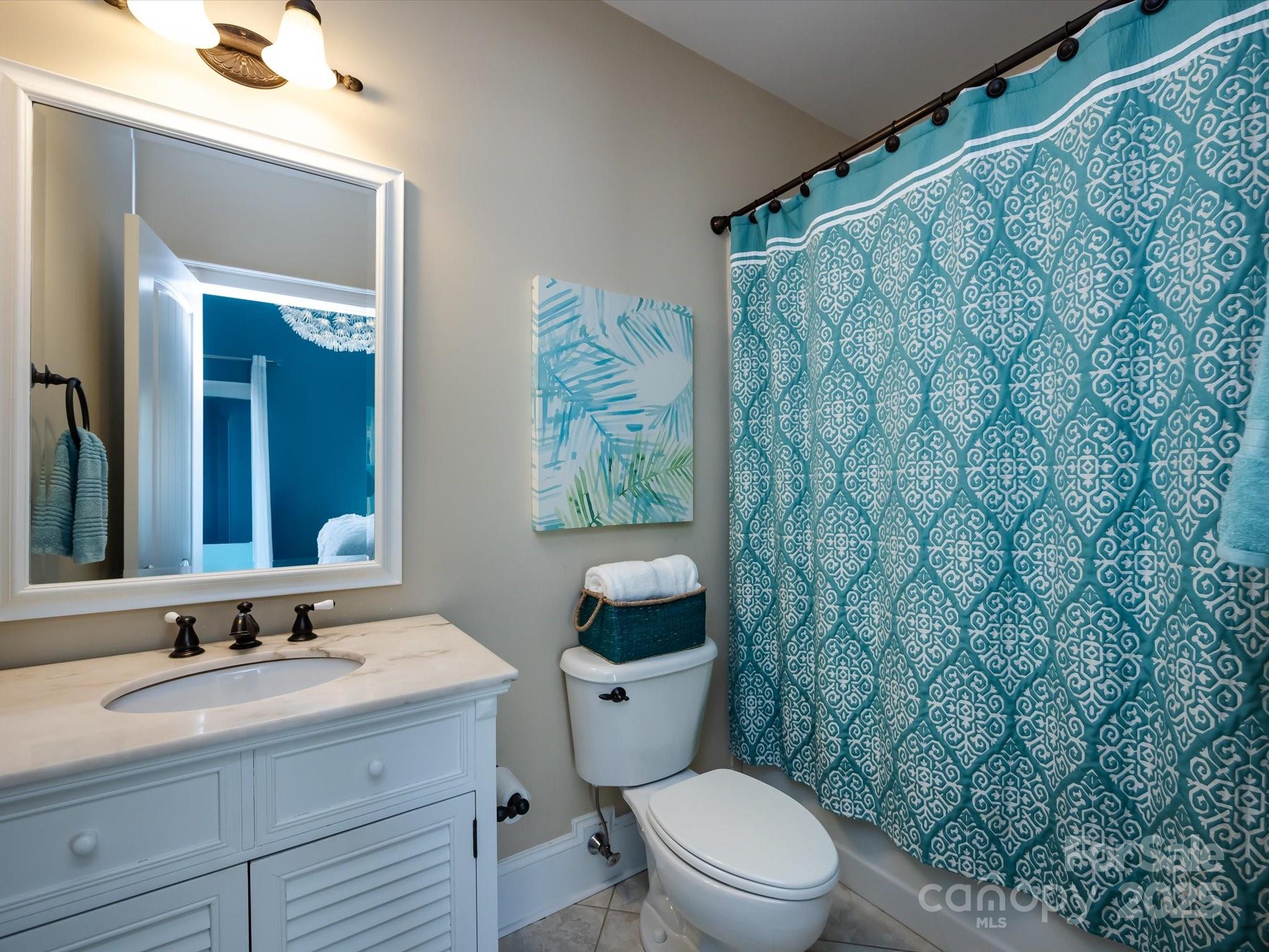 132 Chaska Loop Troutman, NC 28166 - Photo 28 of 48 a bathroom with a granite countertop toilet sink and mirror