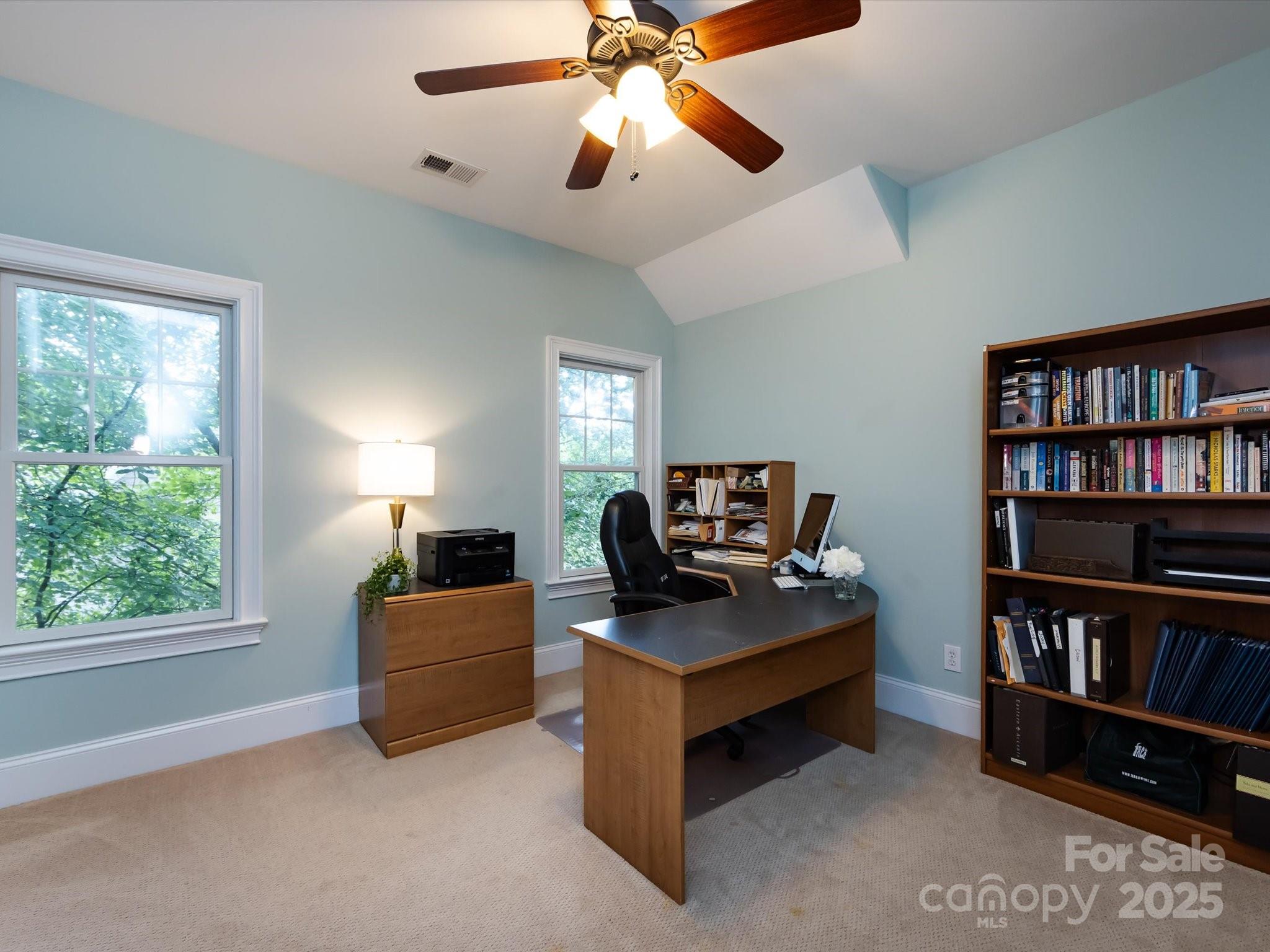 132 Chaska Loop Troutman, NC 28166 - Photo 33 of 48 a living room with furniture and a book shelf