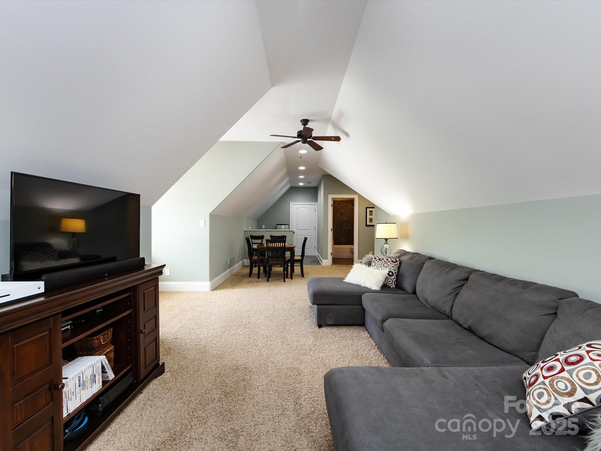 132 Chaska Loop Troutman, NC 28166 - Photo 36 of 48 a living room with furniture and a flat screen tv