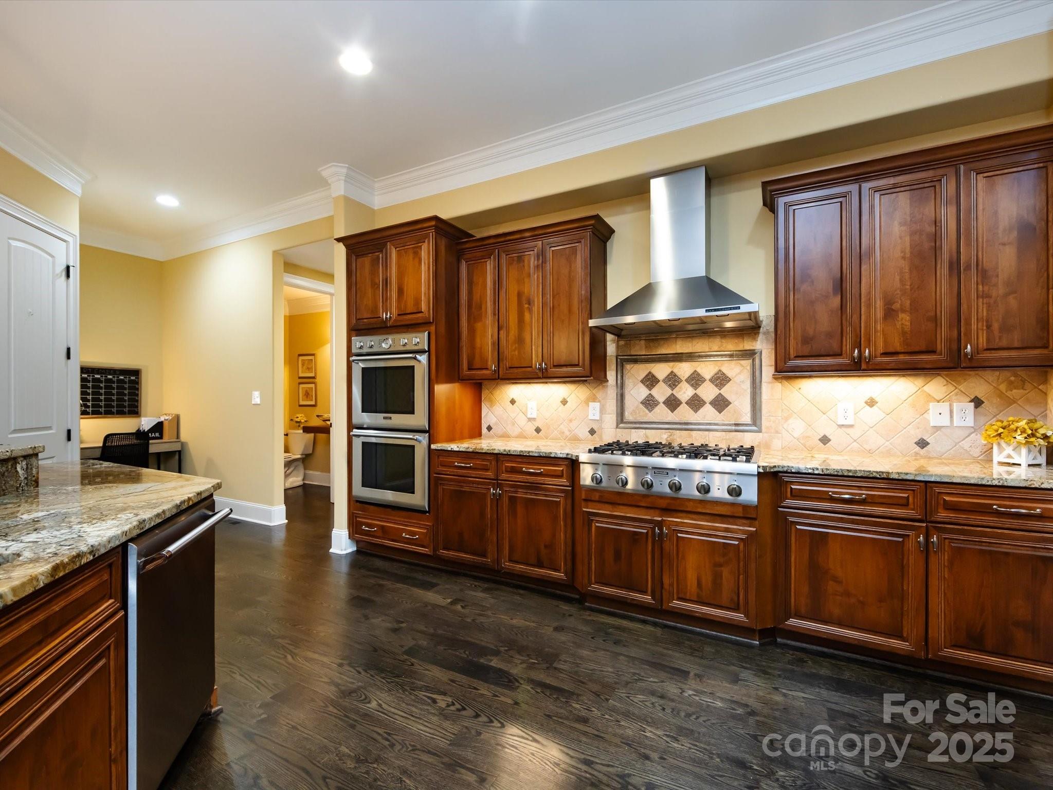 132 Chaska Loop Troutman, NC 28166 - Photo 8 of 48 a kitchen with stainless steel appliances granite countertop a stove sink and cabinets