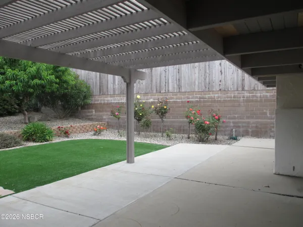 a view of a house with a backyard and garden