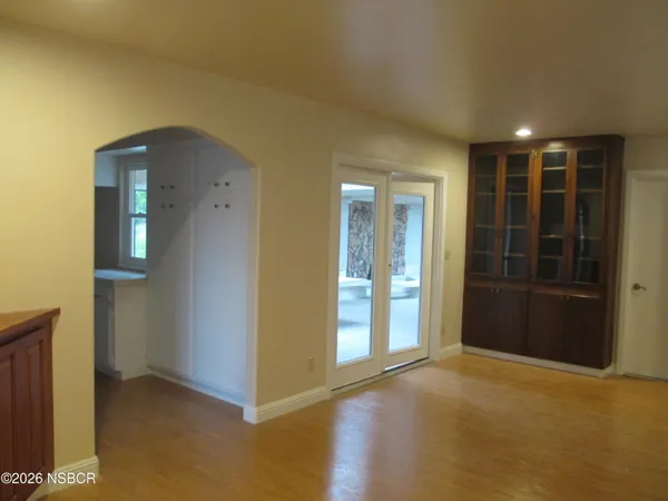 an empty room with closet and wooden floor