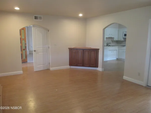 a view of an empty room with a kitchen