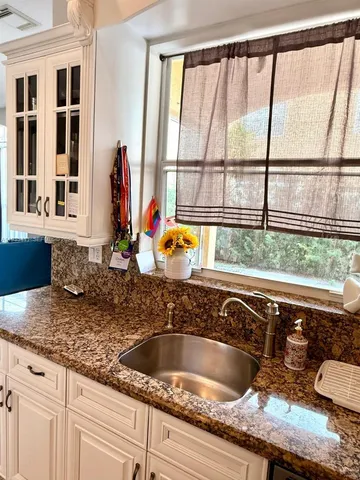 a kitchen with a sink and a window