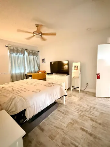 a spacious bathroom with a double vanity sink mirror and bathtub