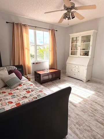 a bedroom with a bed and a window with the outer view