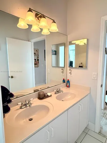 a white toilet next to a bathroom sink