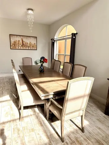 a view of a dining room with furniture and a window