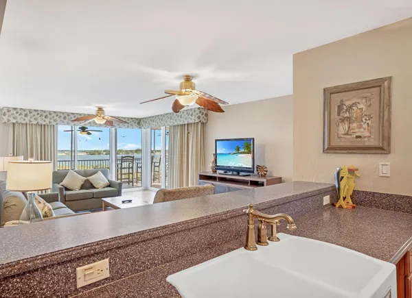 a living room with furniture and kitchen view