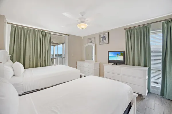 a bedroom with furniture and a large window