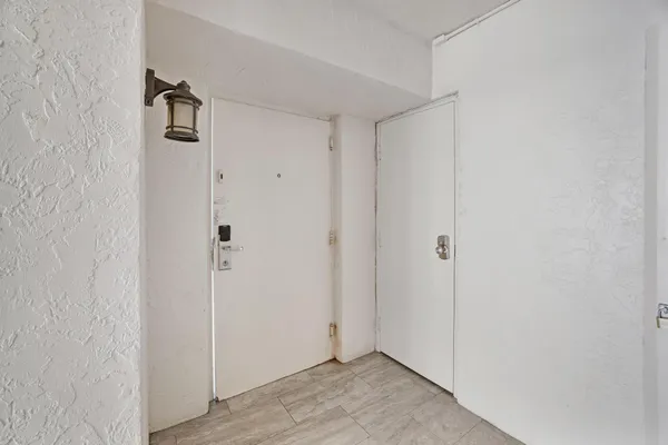 a bathroom with a granite countertop sink a mirror and a shower