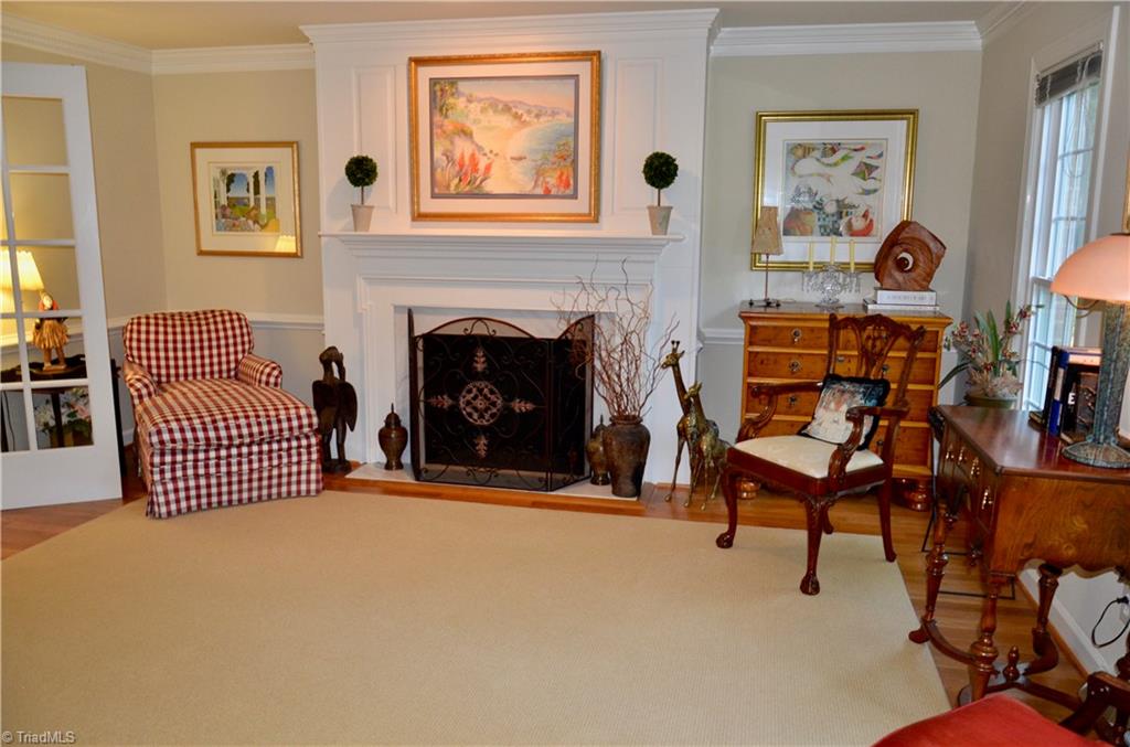 952 Bryanplace Road Winston-Salem, NC 27104 - Photo 3 of 30 LR or Music room with dental molding, faux fireplace and wood floors that were replaced, and wall was opened up between LR/Den and french doors added. Wonderful flow for entertaining.
