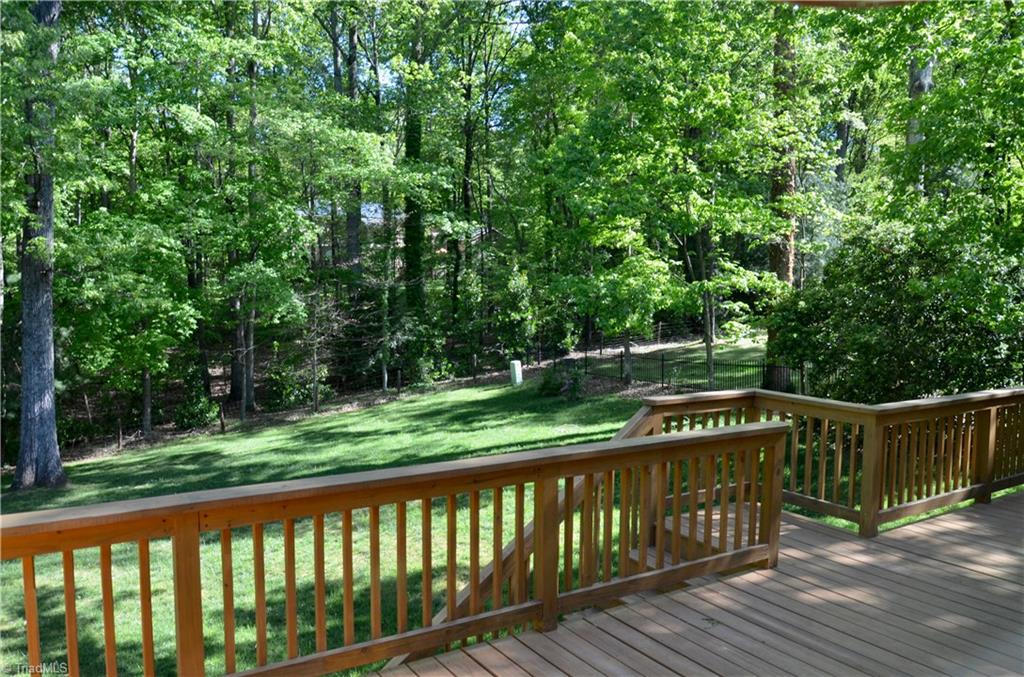952 Bryanplace Road Winston-Salem, NC 27104 - Photo 27 of 30 Wonderful wooded views from large 30 ft deck and concrete patio- replaced in 2017 with some vinyl siding finished up on upper back of house, kitchen, den bays and front dormers.