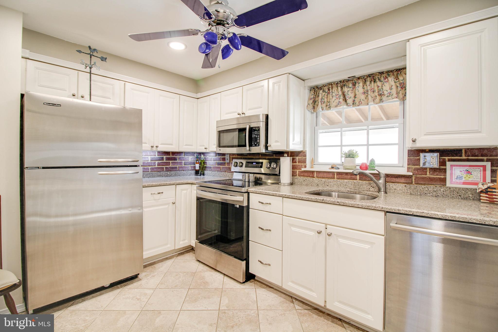 5649 Chelwynd Road Halethorpe, MD 21227 - Photo 9 of 44 a kitchen with granite countertop a refrigerator stove top oven and sink