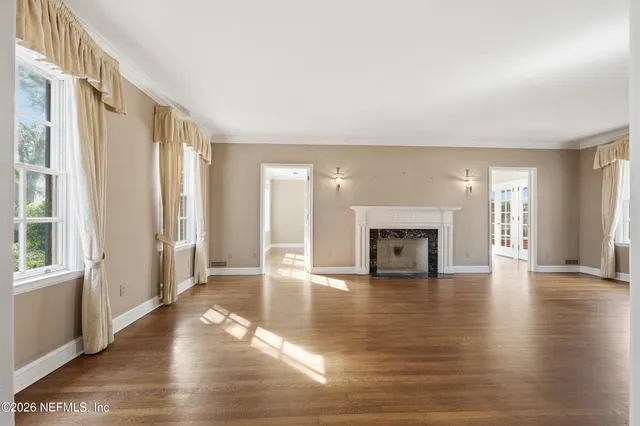 a view of a kitchen with furniture and wooden floor
