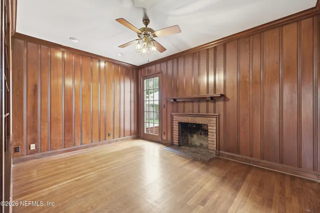 a room with pool table and wooden floor