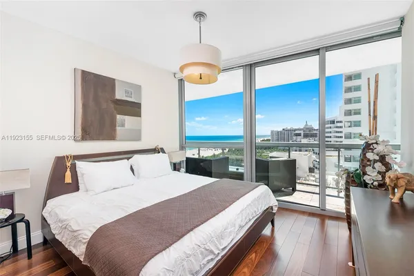 a bedroom with a large bed and a large window