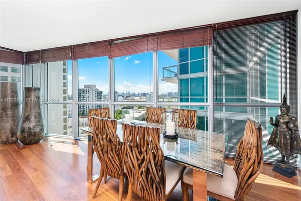 a view of a living room and dining room with wooden floor