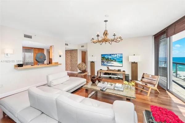 a living room with furniture and a chandelier