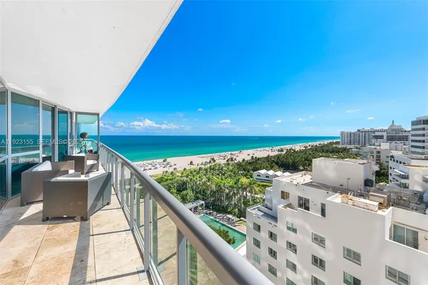 a balcony with wooden floor and city view