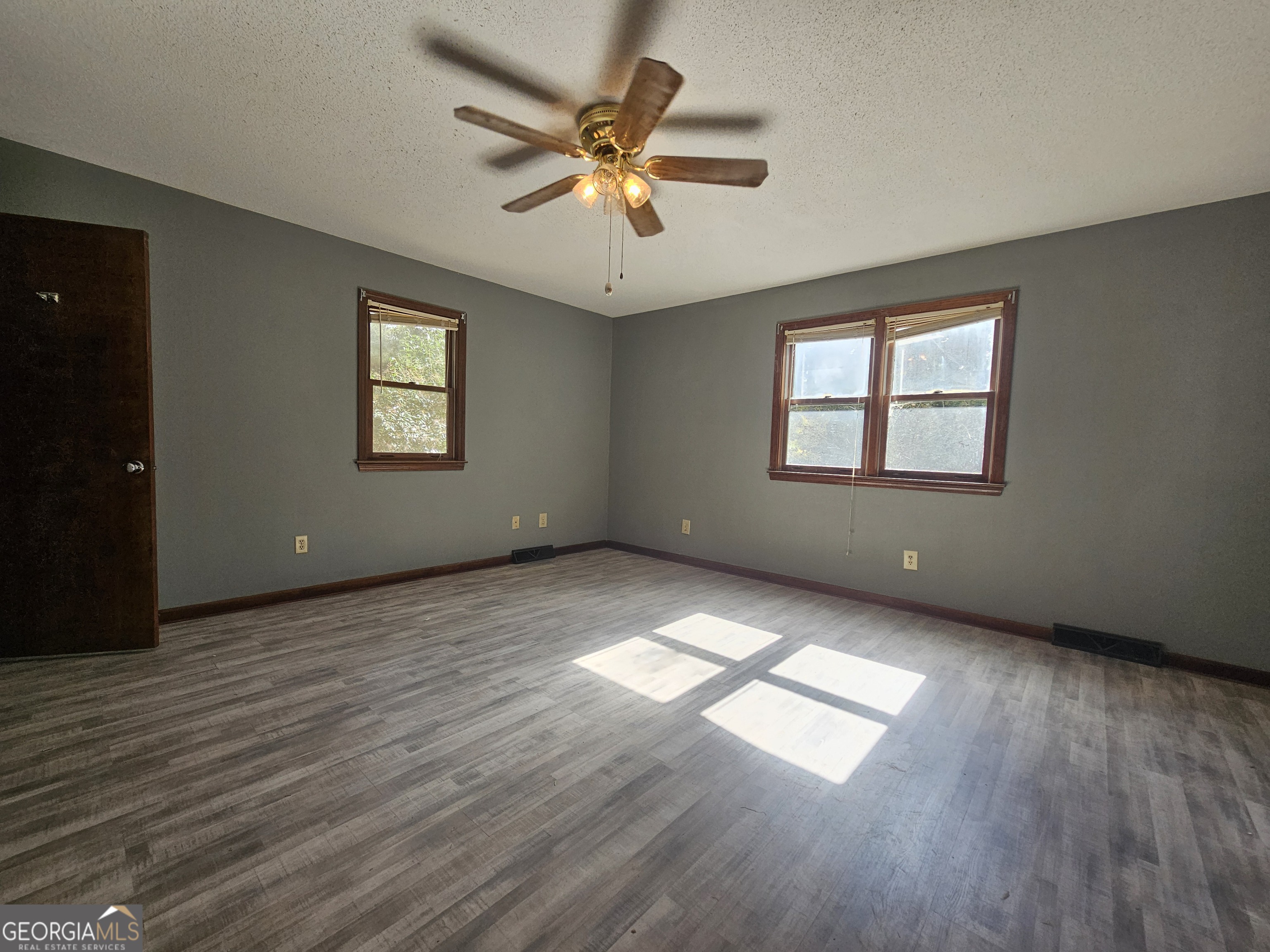 96 Glencrest Drive Toccoa, GA 30577 - Photo 12 of 15 an empty room with wooden floor and windows