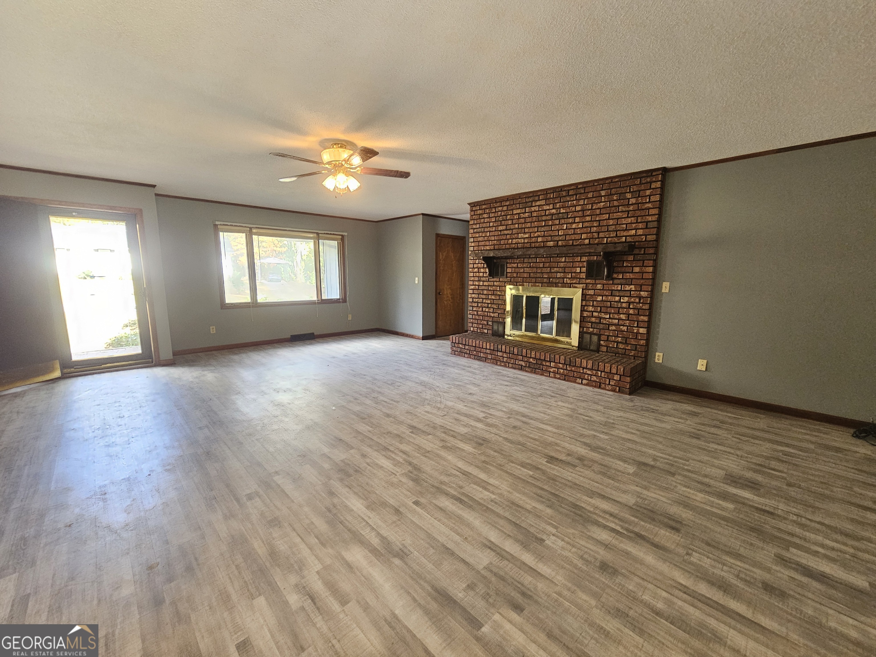 96 Glencrest Drive Toccoa, GA 30577 - Photo 3 of 15 an empty room with wooden floor and windows