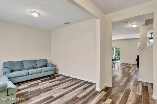 a living room with furniture and a wooden floor