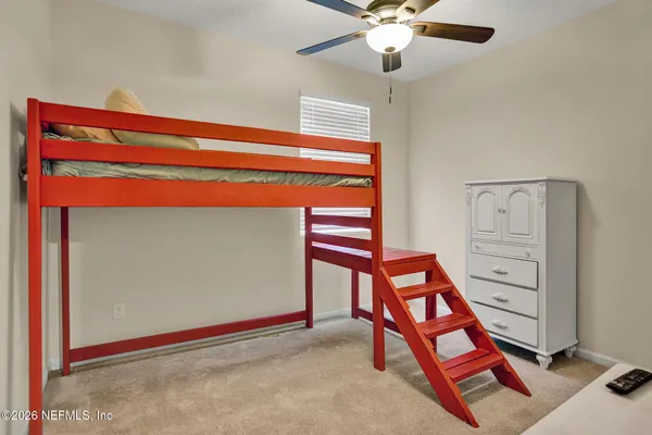 a bedroom with a bed and a mirror