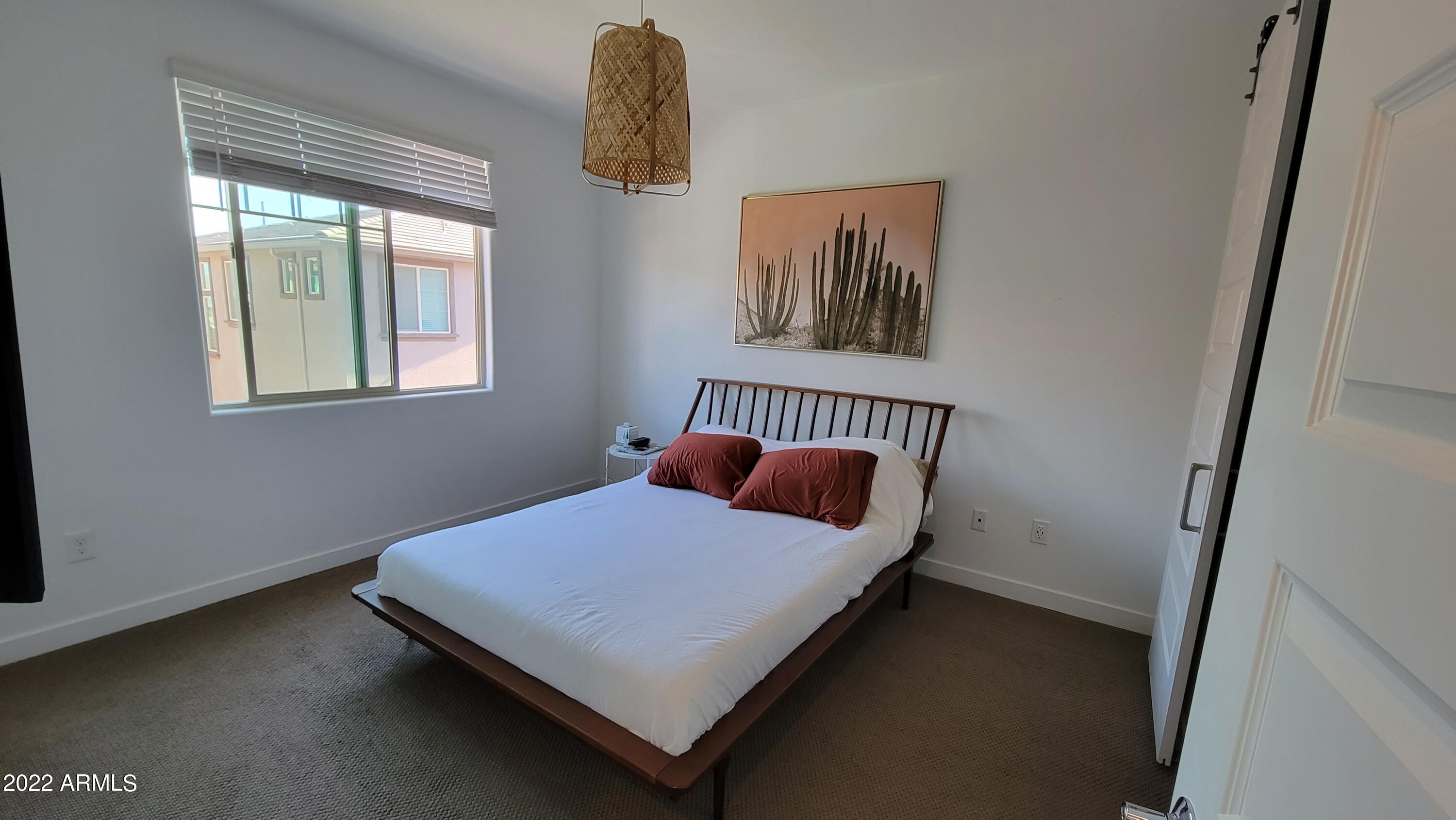 4100 South Pinelake Way, Unit 142 Chandler, AZ 85249 - Photo 15 of 25 a bedroom with a bed and a window