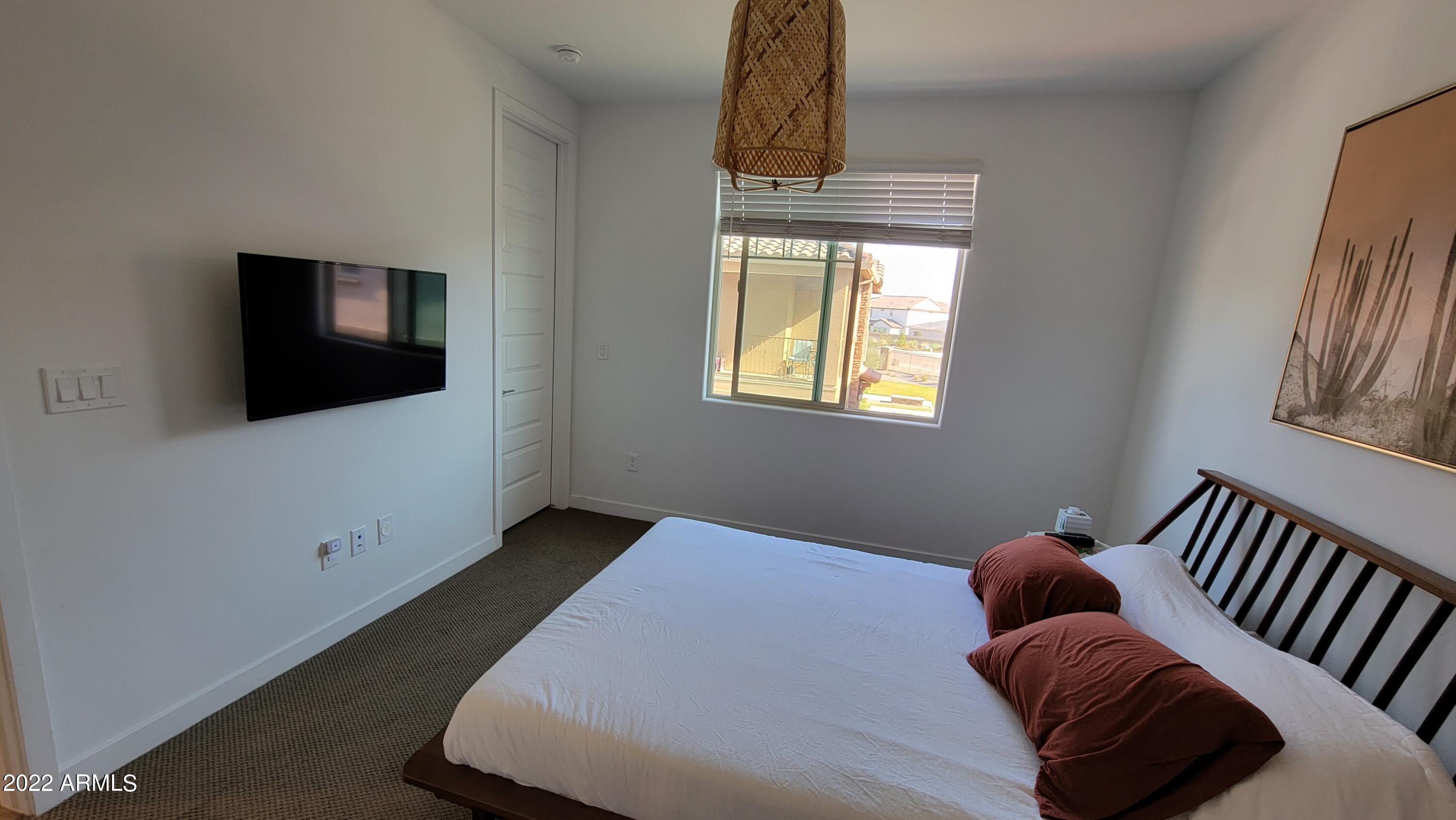 4100 South Pinelake Way, Unit 142 Chandler, AZ 85249 - Photo 16 of 25 a bedroom with furniture and flat screen tv