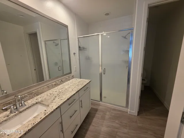a bathroom with a granite countertop sink mirror and double