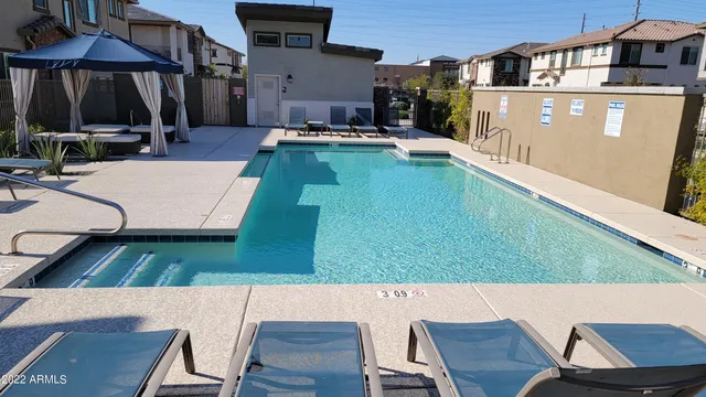 an aerial view of a house with swimming pool having outdoor seating