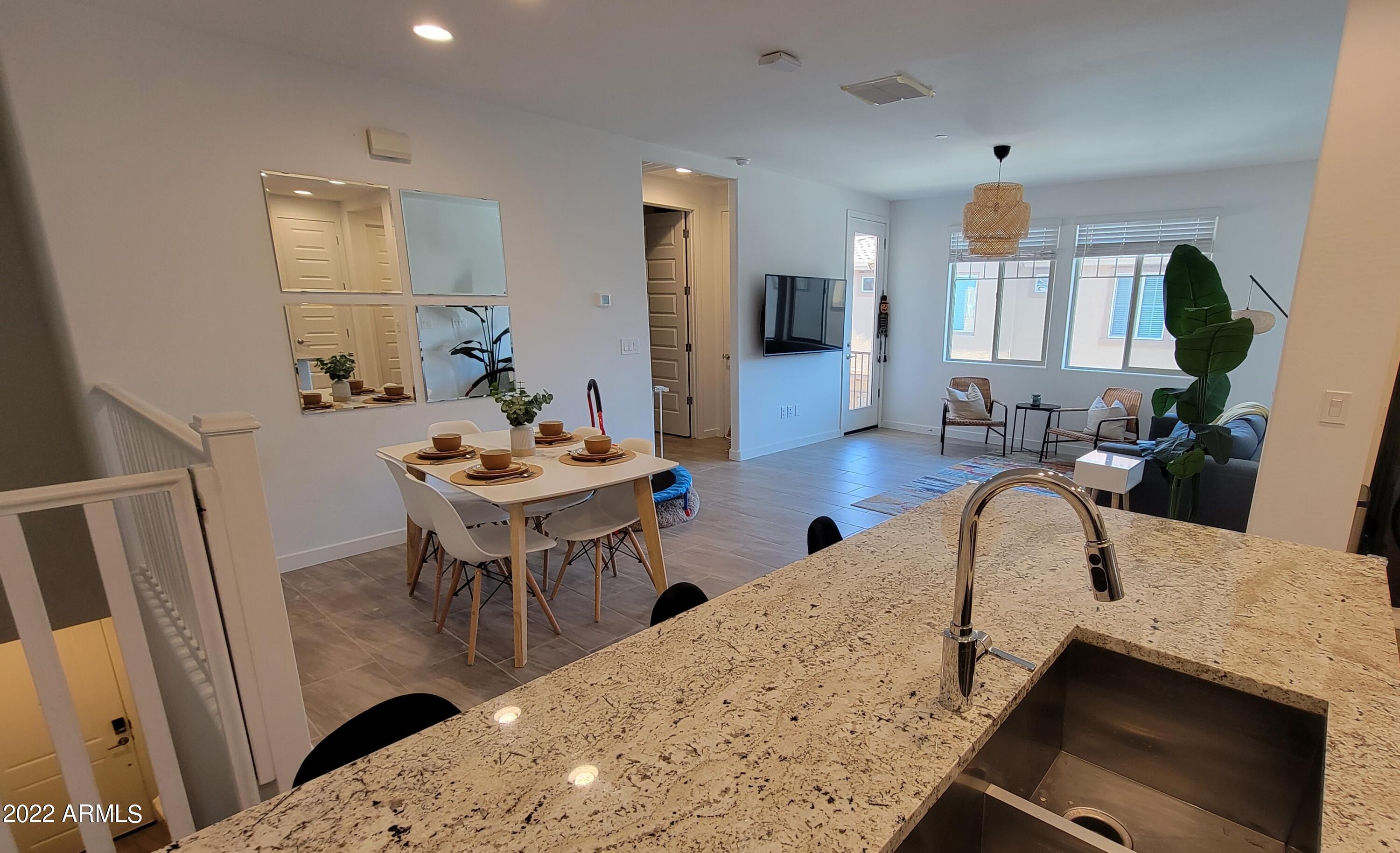 4100 South Pinelake Way, Unit 142 Chandler, AZ 85249 - Photo 6 of 25 a view of a dining room with furniture and wooden floor