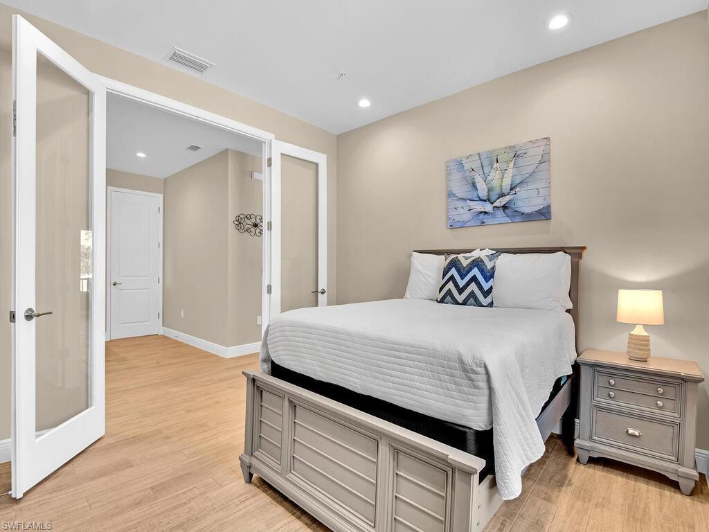 2561 Seychelles Drive, Unit 308 Naples, FL 34112 - Photo 15 of 28 a bed room with a bed and a window